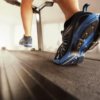 Man running in a gym on a treadmill