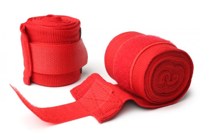 Red boxing bandages on white background